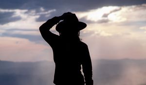 Preview wallpaper silhouette, hat, mountains, dark