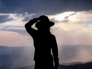 Preview wallpaper silhouette, hat, mountains, dark