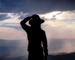 Preview wallpaper silhouette, hat, mountains, dark