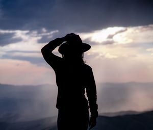 Preview wallpaper silhouette, hat, mountains, dark