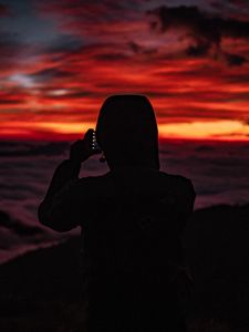 Preview wallpaper silhouette, hood, sunset, darkness