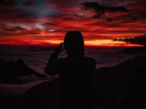 Preview wallpaper silhouette, hood, sunset, darkness