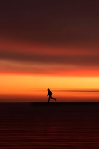 Preview wallpaper silhouette, horizon, running, twilight, sunset, red