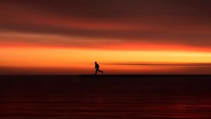 Preview wallpaper silhouette, horizon, running, twilight, sunset, red