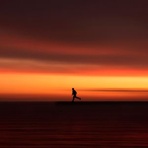 Preview wallpaper silhouette, horizon, running, twilight, sunset, red