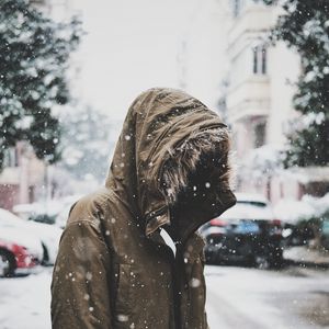 Preview wallpaper silhouette, jacket, hood, snow, winter