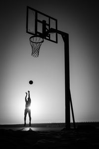 Preview wallpaper silhouette, jump, ball, basketball, sport, black and white
