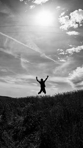 Preview wallpaper silhouette, jump, bw, field, freedom, sky