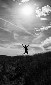 Preview wallpaper silhouette, jump, bw, field, freedom, sky