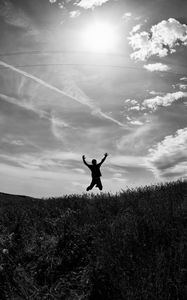 Preview wallpaper silhouette, jump, bw, field, freedom, sky