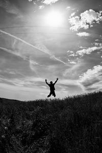 Preview wallpaper silhouette, jump, bw, field, freedom, sky