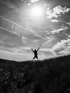 Preview wallpaper silhouette, jump, bw, field, freedom, sky