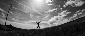 Preview wallpaper silhouette, jump, bw, field, freedom, sky