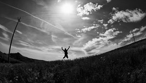 Preview wallpaper silhouette, jump, bw, field, freedom, sky