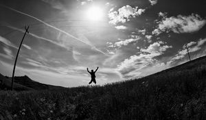 Preview wallpaper silhouette, jump, bw, field, freedom, sky