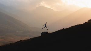 Preview wallpaper silhouette, jump, mountains, light, dark