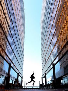 Preview wallpaper silhouette, jump, night, buildings