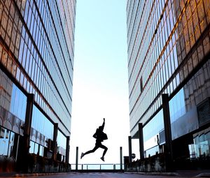 Preview wallpaper silhouette, jump, night, buildings