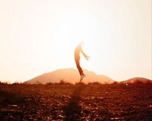 Preview wallpaper silhouette, jump, sunlight, sunset, bright
