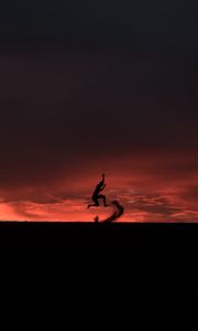 Preview wallpaper silhouette, jump, sunset, night