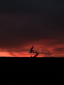 Preview wallpaper silhouette, jump, sunset, night