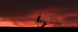 Preview wallpaper silhouette, jump, sunset, night