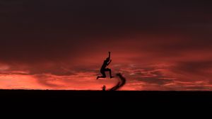 Preview wallpaper silhouette, jump, sunset, night