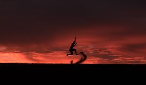 Preview wallpaper silhouette, jump, sunset, night