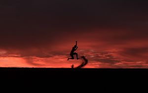 Preview wallpaper silhouette, jump, sunset, night