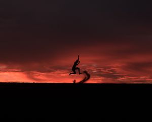 Preview wallpaper silhouette, jump, sunset, night