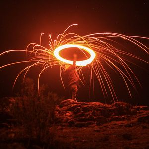 Preview wallpaper silhouette, light, sparks, dark, long exposure