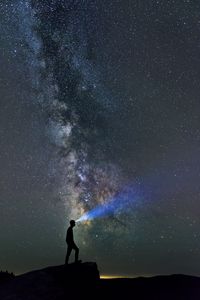 Preview wallpaper silhouette, loneliness, alone, flashlight, starry sky