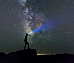 Preview wallpaper silhouette, loneliness, alone, flashlight, starry sky