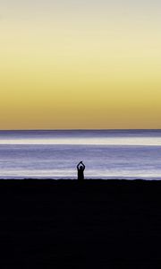 Preview wallpaper silhouette, loneliness, alone, beach, sunset, sea