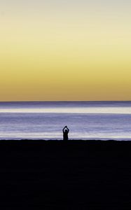 Preview wallpaper silhouette, loneliness, alone, beach, sunset, sea