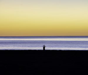 Preview wallpaper silhouette, loneliness, alone, beach, sunset, sea