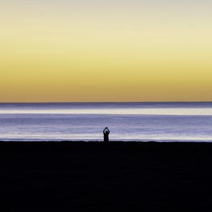 Preview wallpaper silhouette, loneliness, alone, beach, sunset, sea