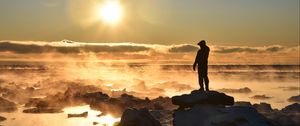 Preview wallpaper silhouette, loneliness, rocks, stones, fog, clouds, sunset