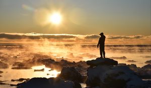 Preview wallpaper silhouette, loneliness, rocks, stones, fog, clouds, sunset