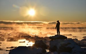 Preview wallpaper silhouette, loneliness, rocks, stones, fog, clouds, sunset