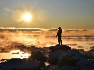 Preview wallpaper silhouette, loneliness, rocks, stones, fog, clouds, sunset