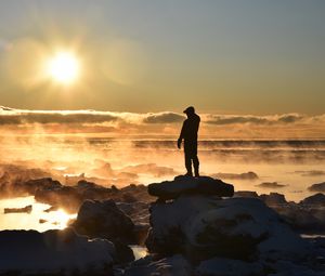 Preview wallpaper silhouette, loneliness, rocks, stones, fog, clouds, sunset