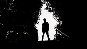 Preview wallpaper silhouette, man, dark, trees