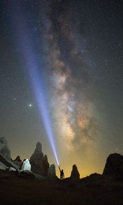 Preview wallpaper silhouette, man, lantern, glow, starry sky, rocks