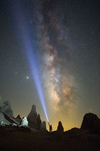 Preview wallpaper silhouette, man, lantern, glow, starry sky, rocks