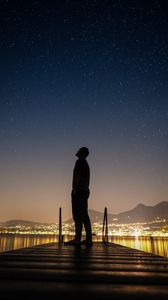 Preview wallpaper silhouette, man, night city, stars, starry sky