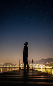 Preview wallpaper silhouette, man, night city, stars, starry sky