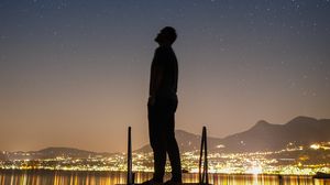 Preview wallpaper silhouette, man, night city, stars, starry sky
