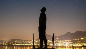 Preview wallpaper silhouette, man, night city, stars, starry sky