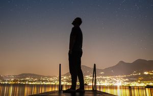 Preview wallpaper silhouette, man, night city, stars, starry sky